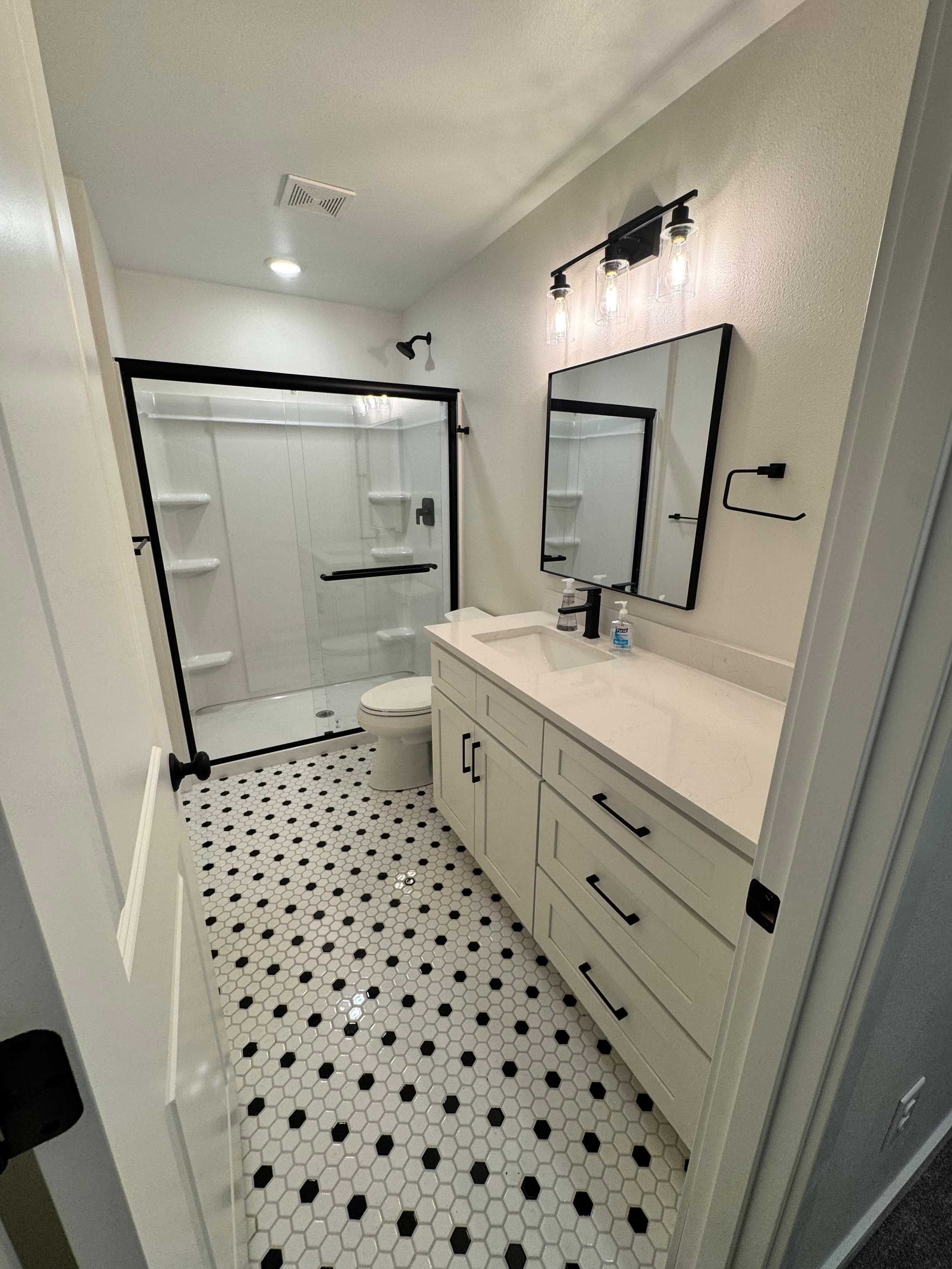 Finished Fast Bath upgrade with brighter vanity, shower, and flooring